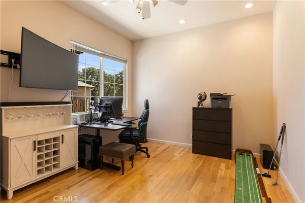 a dining area with stainless steel appliances a table chairs and kitchen view