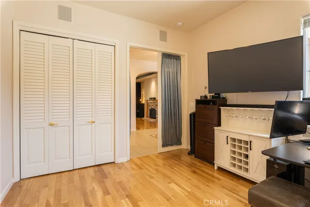 a kitchen with stainless steel appliances granite countertop a sink a stove a refrigerator and island with wooden floor