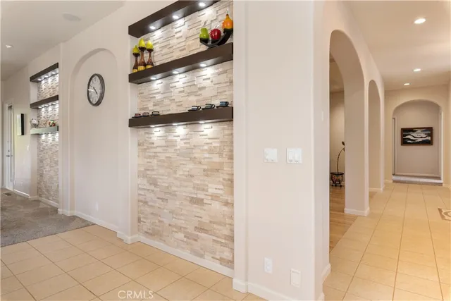 a kitchen with granite countertop white cabinets and stainless steel appliances