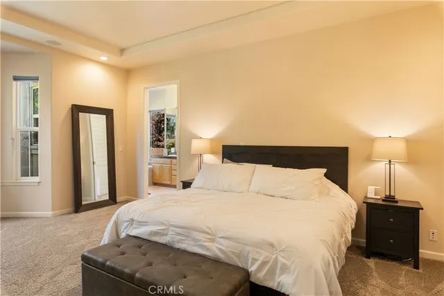 a view of a bedroom with a window and a bedroom