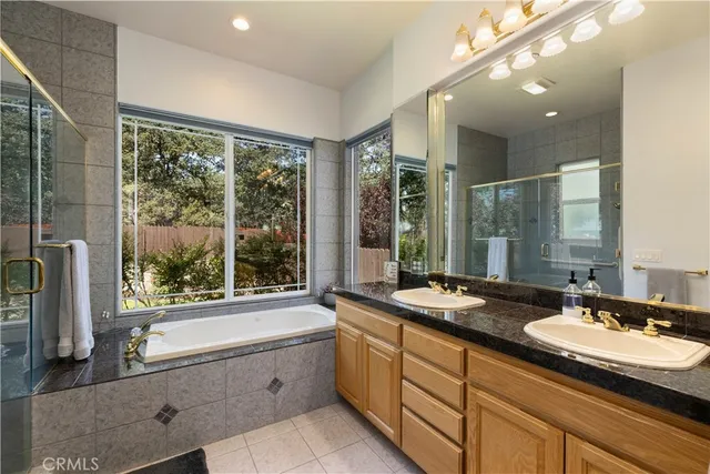 a bathroom with a double sink shower and a mirror