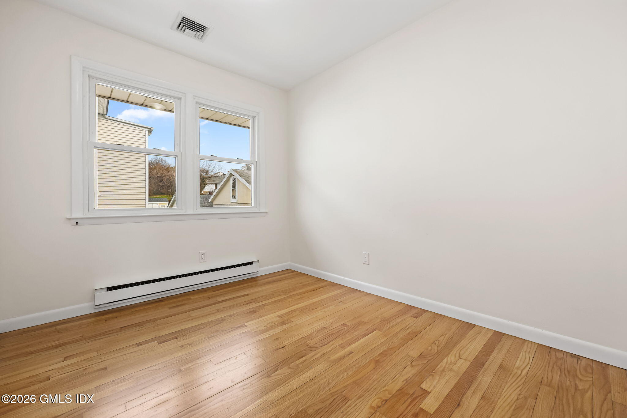 2 Grange Street Greenwich, CT 06830 - Photo 7 of 31 an empty room with wooden floor and windows
