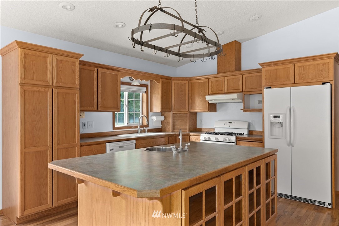 491 South Military Road Winlock, WA 98596 - Photo 8 of 40 a kitchen with stainless steel appliances granite countertop a sink a stove and refrigerator