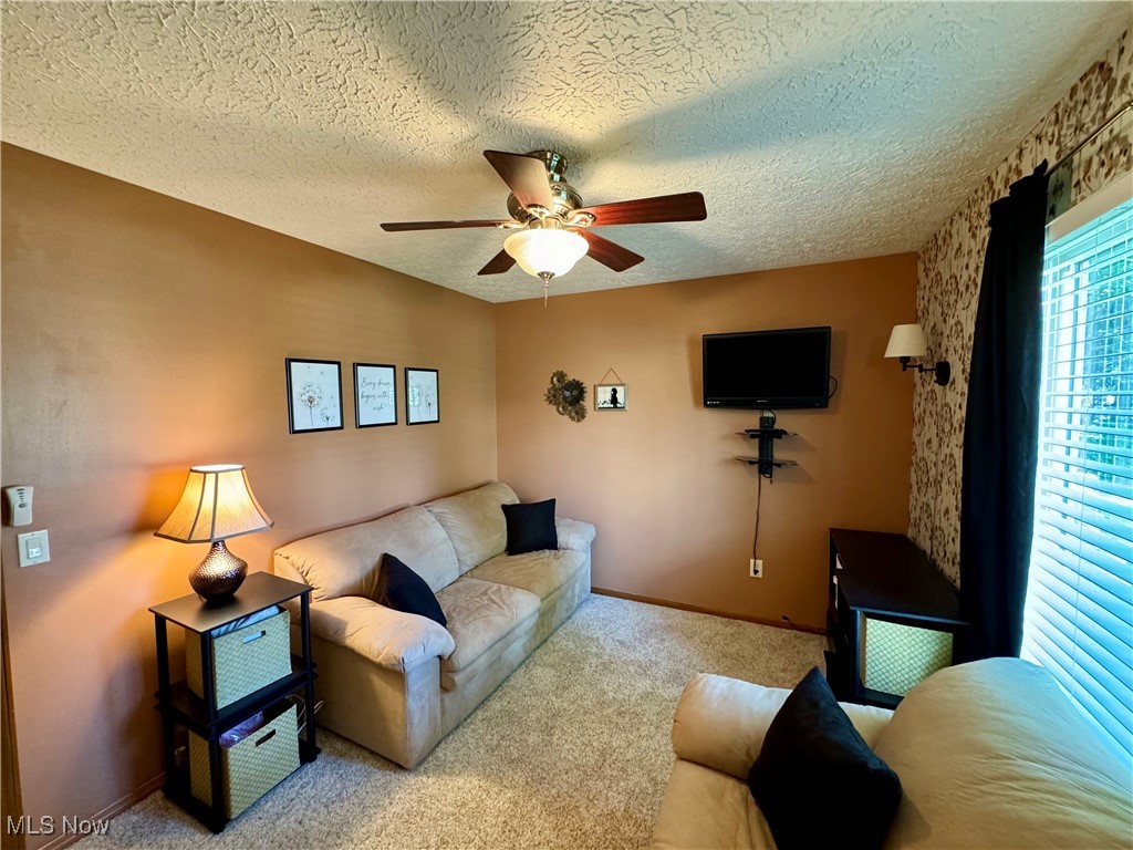 1499 Welch Road Painesville, OH 44077 - Photo 18 of 22 Carpeted bedroom featuring a textured ceiling and ceiling fan