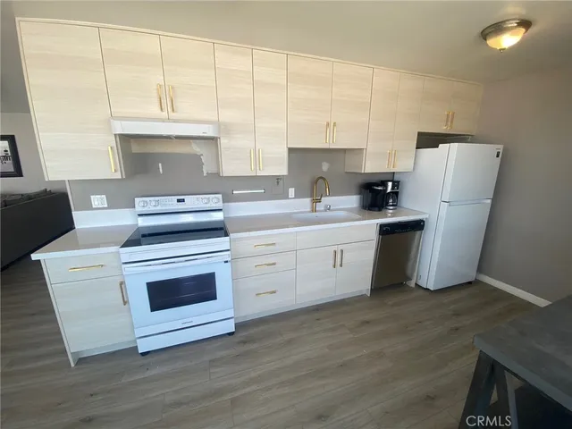 a living room with furniture floor to ceiling window and wooden floor