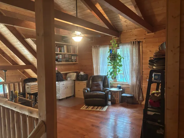 a view of a room with a large window and front door