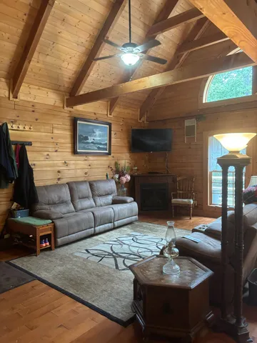 a living room with furniture and a floor to ceiling window