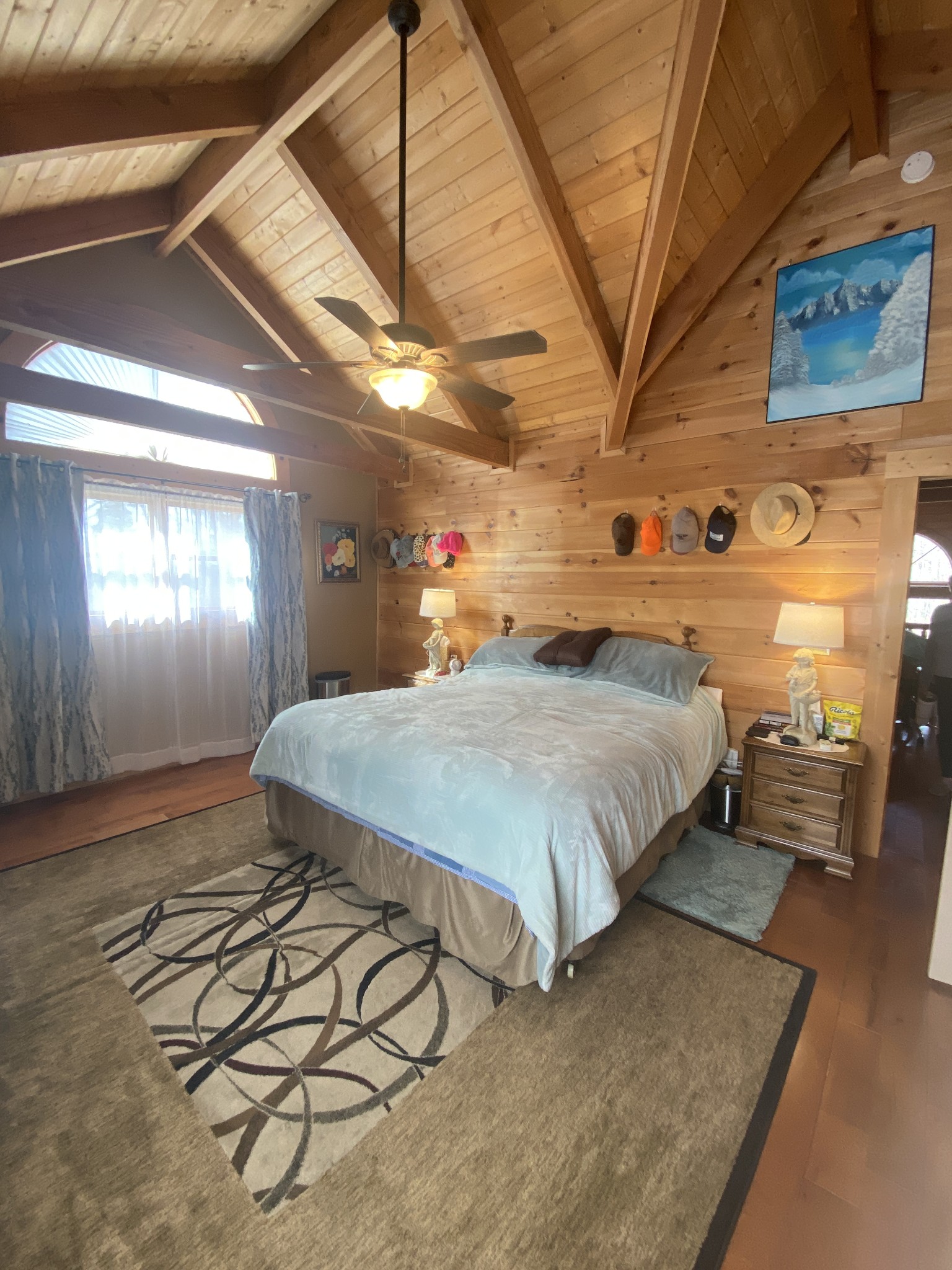 271 Ingman Clf Road Tracy City, TN 37387 - Photo 44 of 70 a spacious bedroom with a bed a table and painting on the wall