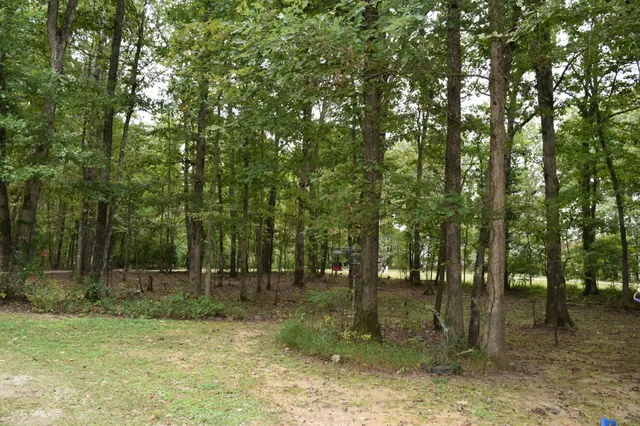 a view of a patio with furniture and a garden