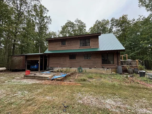 a view of a house with a yard and sitting area