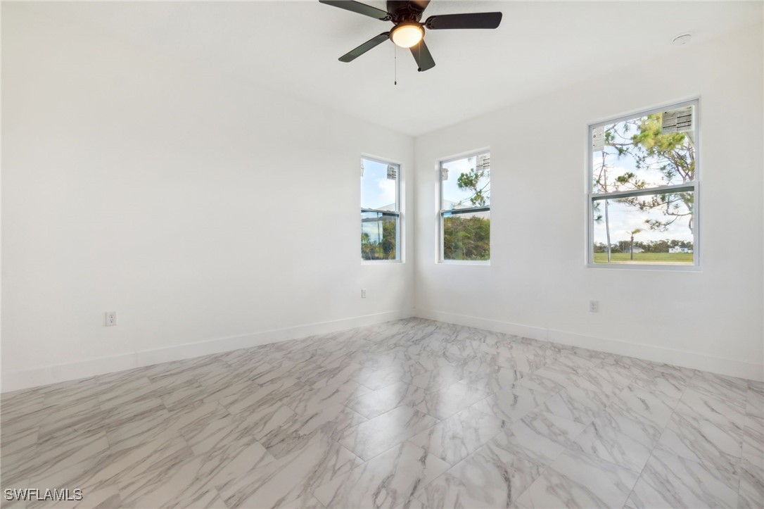 8 Cleat Court Placida, FL 33946 - Photo 12 of 24 an empty room with wooden floor fan and windows