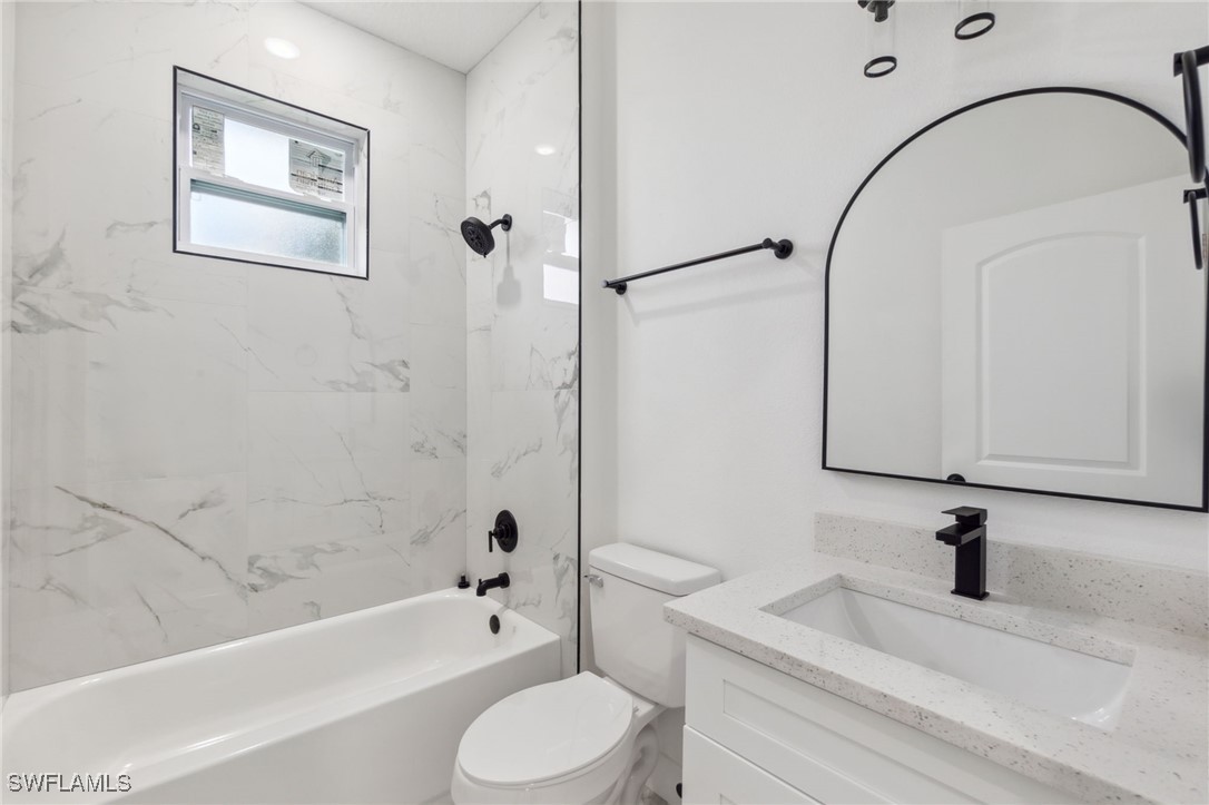 8 Cleat Court Placida, FL 33946 - Photo 21 of 24 a bathroom with a granite countertop bathtub sink vanity mirror and toilet