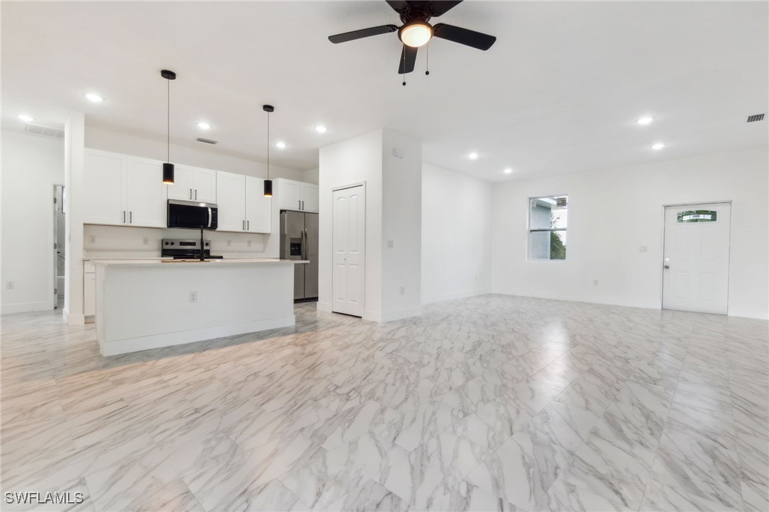 8 Cleat Court Placida, FL 33946 - Photo 5 of 24 a view of a kitchen with kitchen island a sink wooden floor and a refrigerator