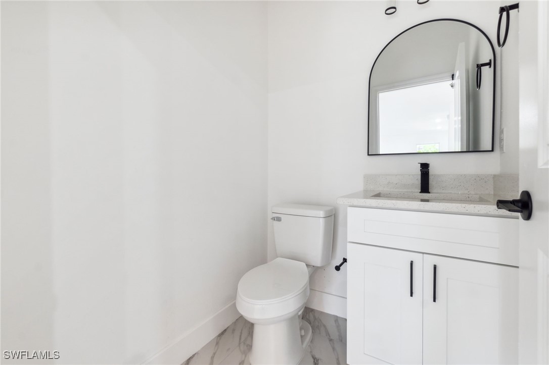 8 Cleat Court Placida, FL 33946 - Photo 9 of 24 a bathroom with a toilet sink and mirror