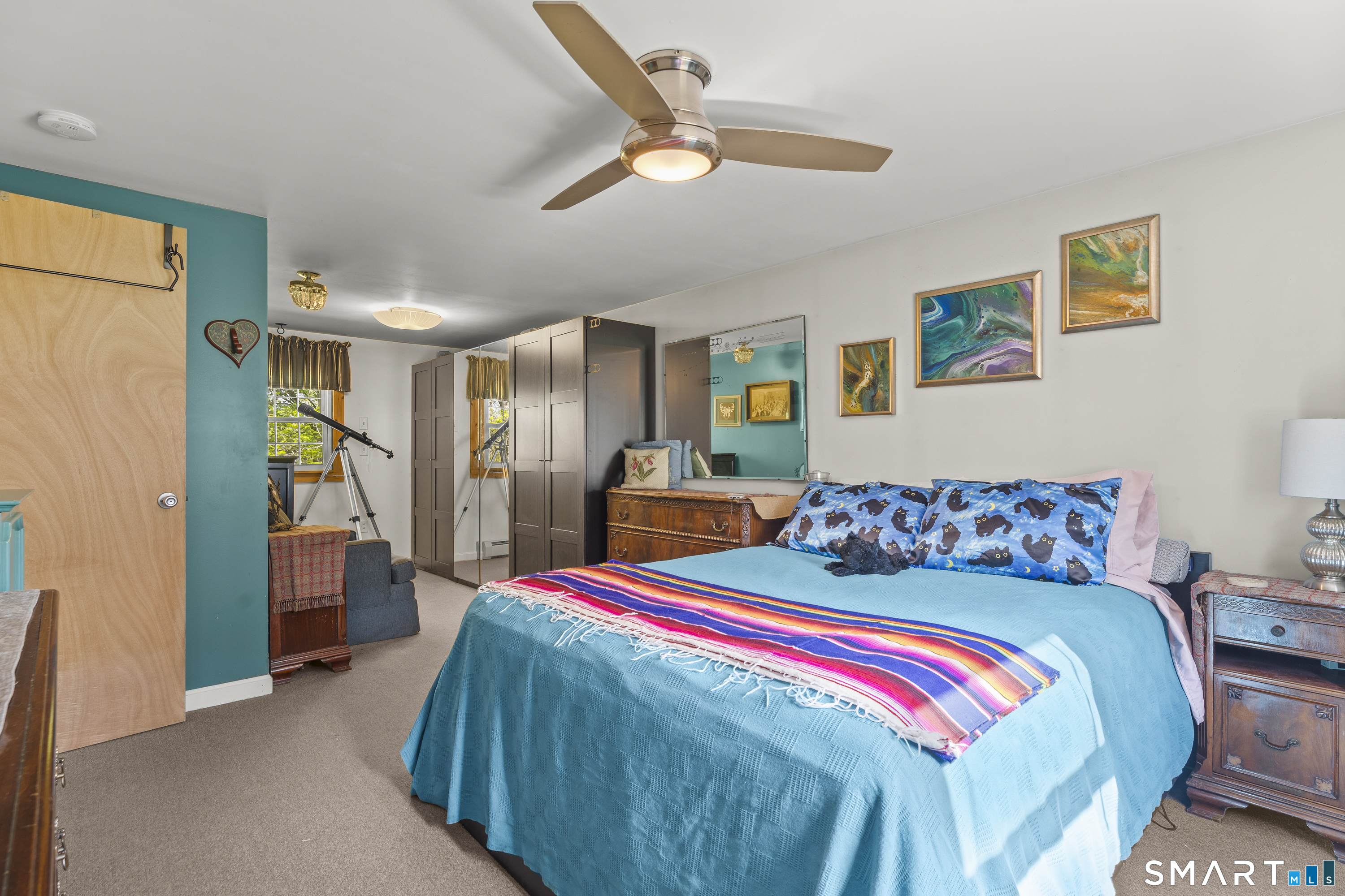 239 Haley Road Ledyard, CT 06339 - Photo 14 of 40 a bedroom with a bed and a chandelier