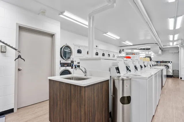 a utility room with sink dryer and washer