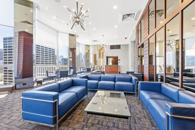 a living room with furniture ceiling fan and a rug