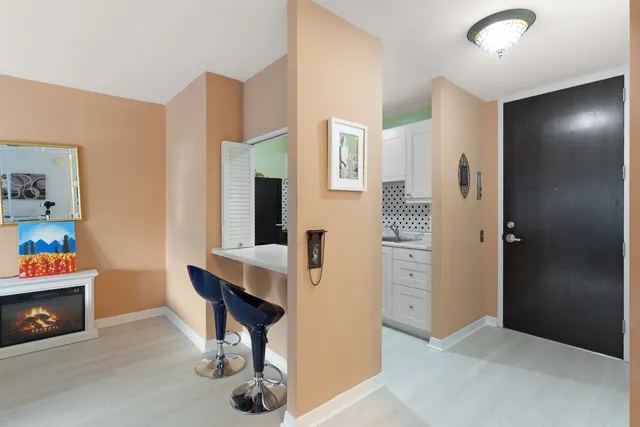 a view of kitchen with livingroom and hardwood floor