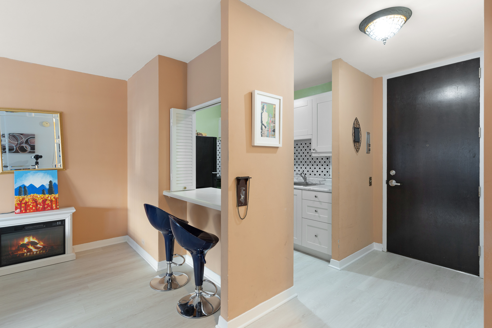 535 North Michigan Avenue, Unit 1710 Chicago, IL 60611 - Photo 5 of 17 a view of kitchen with livingroom and hardwood floor