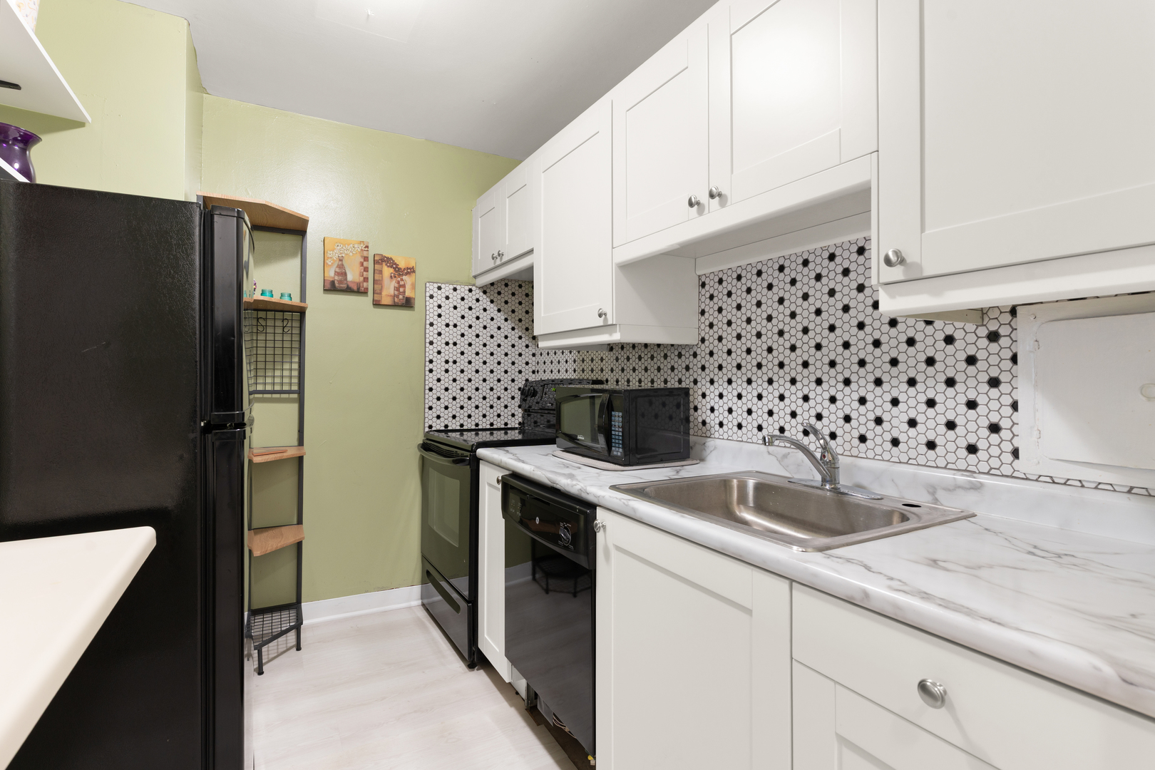 535 North Michigan Avenue, Unit 1710 Chicago, IL 60611 - Photo 8 of 17 a kitchen with granite countertop a sink toilet and refrigerator