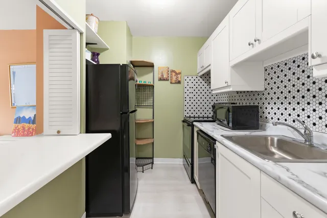 a kitchen with a sink and a refrigerator