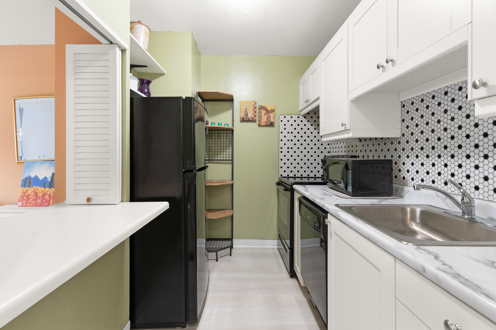 535 North Michigan Avenue, Unit 1710 Chicago, IL 60611 - Photo 9 of 17 a kitchen with a sink and a refrigerator