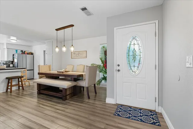 a living room with furniture a window and wooden floor