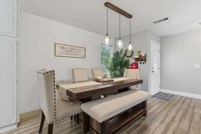 a view of a dining room with furniture and chandelier