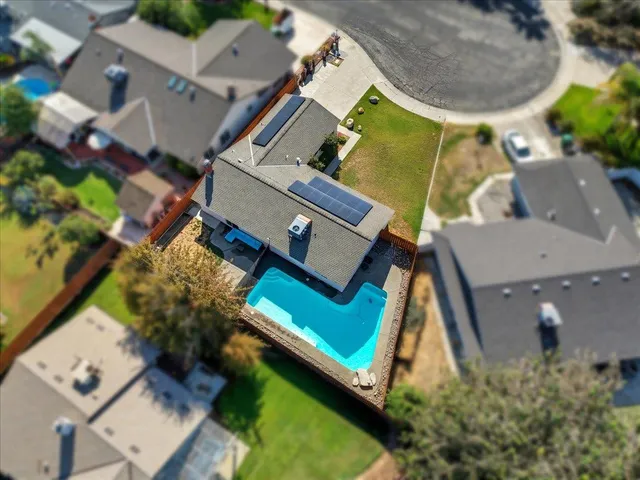 an aerial view of a house with a swimming pool