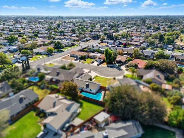 an aerial view of a residential houses with outdoor space