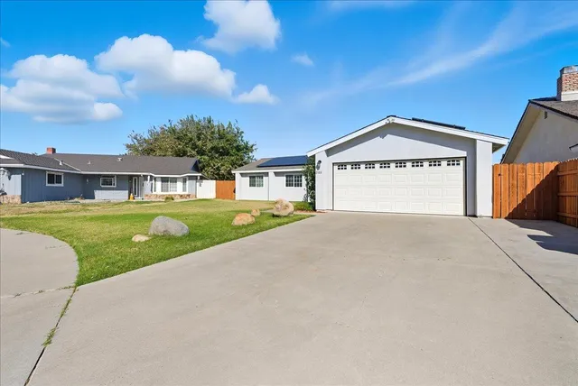 a front view of a house with a big yard
