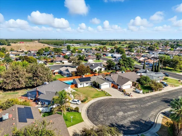 an aerial view of a house with a swimming pool outdoor seating and yard
