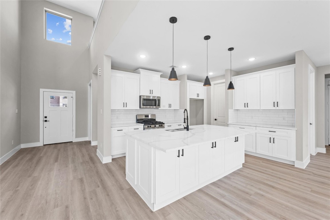 2515 Liguria Spring Spring, TX 77388 - Photo 13 of 15 a large white kitchen with wooden floor
