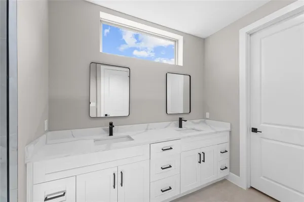 a bathroom with a granite countertop toilet a sink and shower
