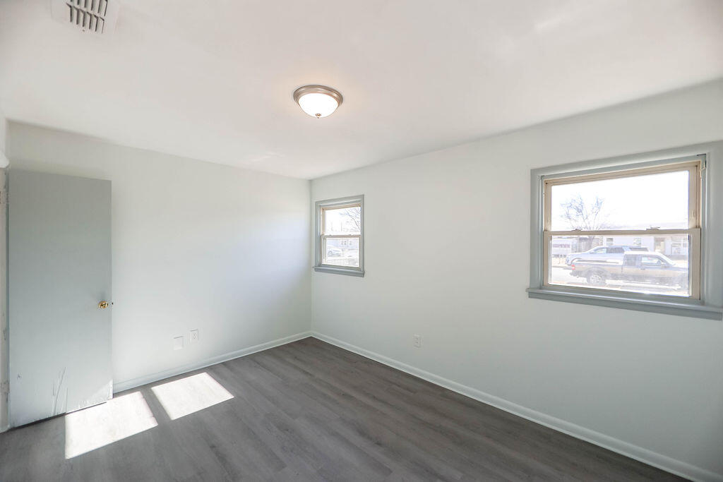 532 54th Street Lubbock, TX 79404 - Photo 13 of 19 an empty room with wooden floor and windows