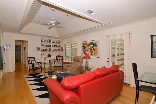 a living room with furniture a table and wooden floor
