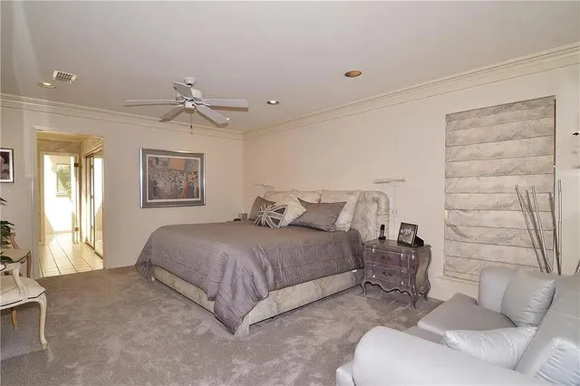 a spacious bedroom with a bed and a couch