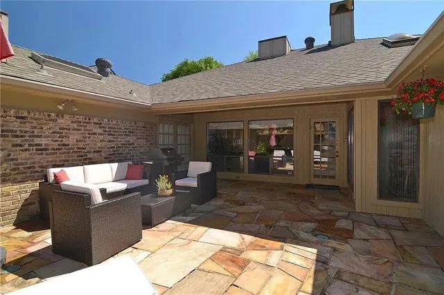 a view of a patio with table and chairs a barbeque