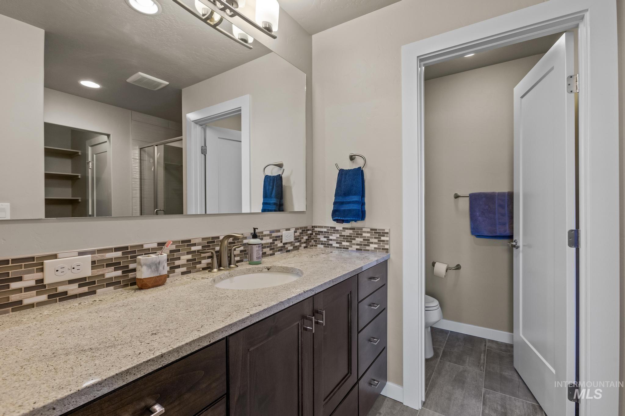 3362 East Exacta Lane Boise, ID 83716 - Photo 29 of 41 Full bathroom featuring tasteful backsplash, vanity, a stall shower, recessed lighting, and a closet