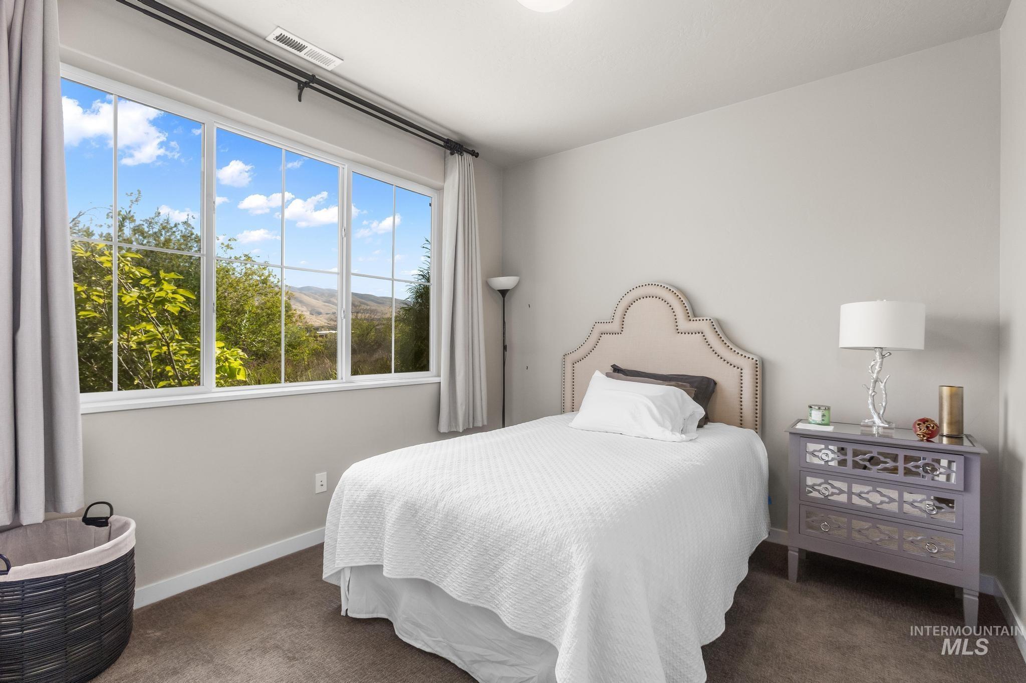 3362 East Exacta Lane Boise, ID 83716 - Photo 7 of 41 Bedroom featuring dark carpet and a mountain view