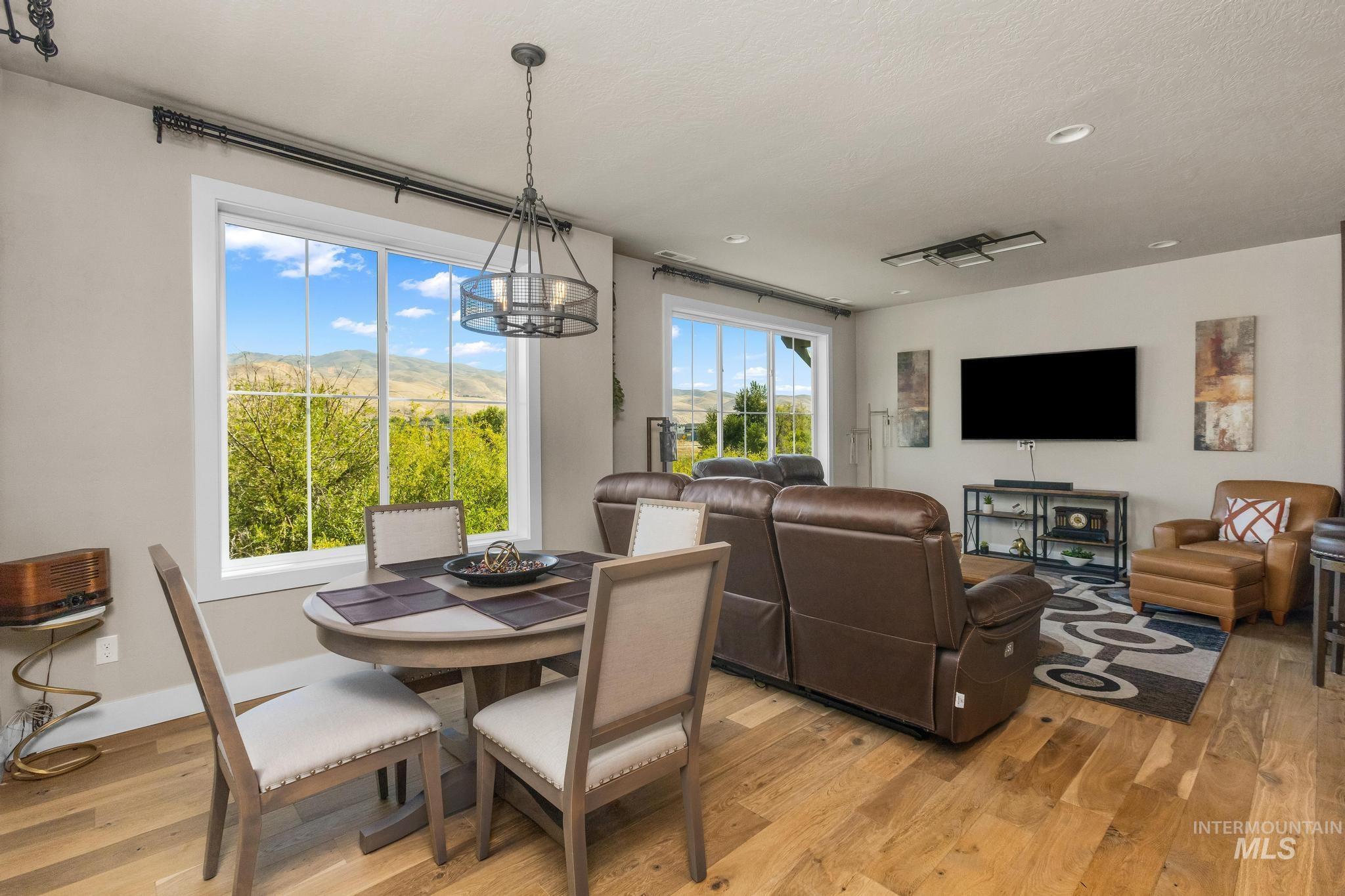 3362 East Exacta Lane Boise, ID 83716 - Photo 10 of 41 Dining room with light wood-style floors, a chandelier, and recessed lighting