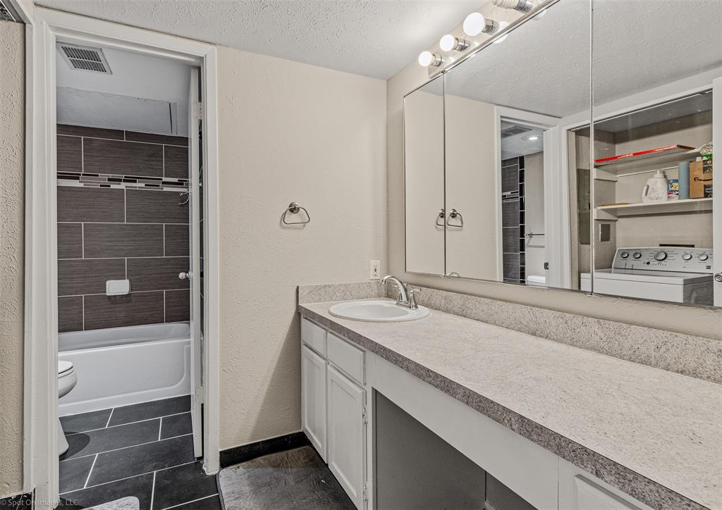 4557 North O'Connor Road, Unit 2281 Irving, TX 75062 - Photo 12 of 21 a bathroom with a sink and a mirror