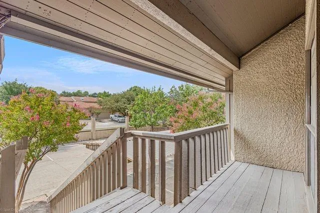 a view of a balcony with wooden floor