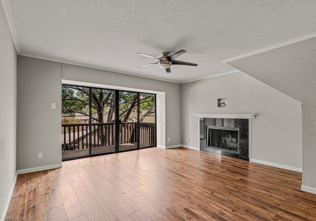 4557 North O'Connor Road, Unit 2281 Irving, TX 75062 - Photo 3 of 21 a view of an empty room with wooden floor and a fireplace
