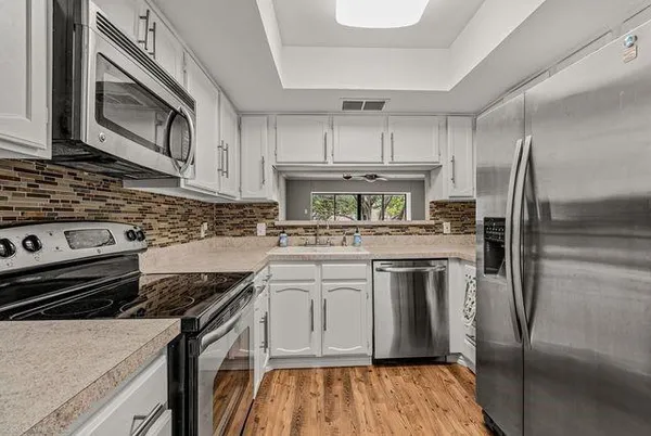 a kitchen with a stove microwave and refrigerator