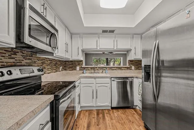 a kitchen with a stove microwave and refrigerator