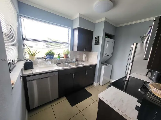 a kitchen that has a sink and a stove top oven