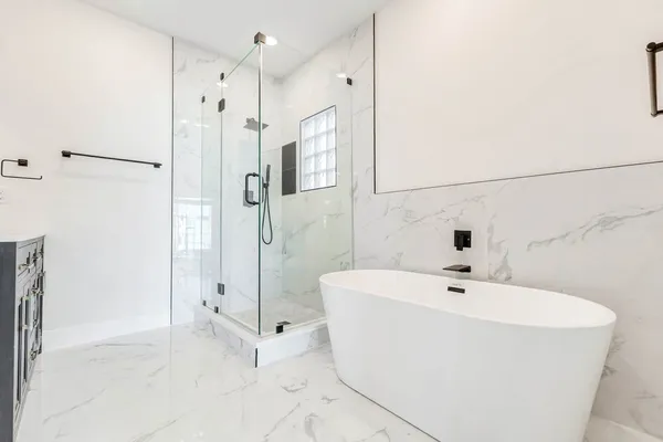 a white bath tub sitting next to a bathroom