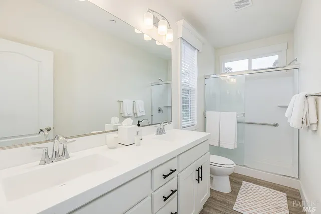 a bathroom with a sink double vanity and a toilet