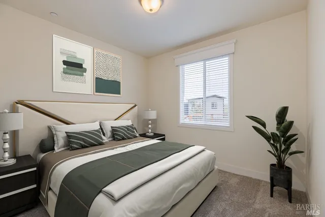 a bedroom with bed and a potted plant